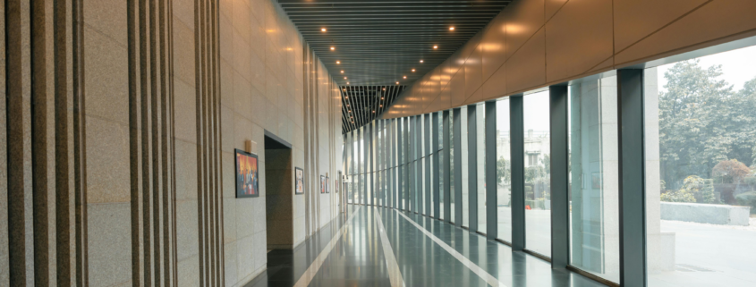 Clean commercial hallway with polished floors and natural light