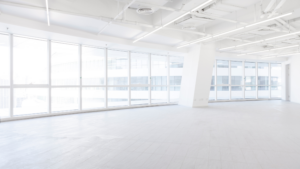 Bright empty commercial space after construction cleaning with large windows and clean floors