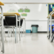 Clean classroom with organized desks and chairs prepared for students before the school day begins.