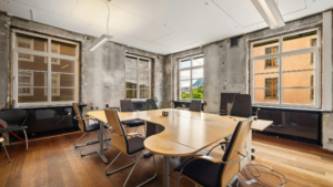 Clean office hallway with glass partitions, break area, and organized workspace maintained through routine cleaning.