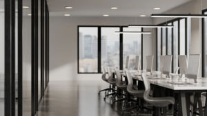 Modern office conference room with glass walls, large meeting table, and organized workspace prepared for client meetings.