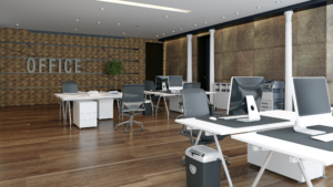 Professional office workspace with desks, computers, and clean wood flooring.