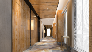 Clean commercial hallway with wood finishes, carpet flooring, and modern lighting.