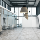 Modern office interior with glass offices, clean floors, and open workspace design.
