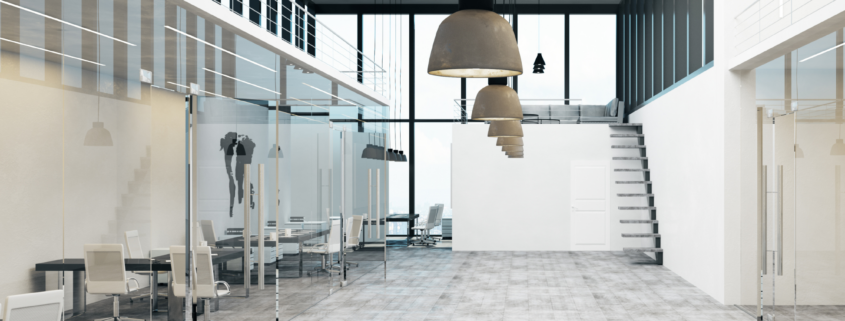 Modern office interior with glass offices, clean floors, and open workspace design.