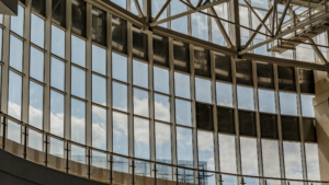 Commercial building glass facade reflecting the sky after professional window cleaning.