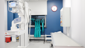 Clean hospital hallway with patient seating and treatment rooms