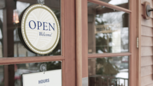 Large commercial storefront with clean glass doors and reflective windows.
