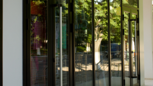 Large commercial storefront with clean glass doors and reflective windows.
