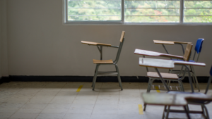 Empty classroom with student desks and natural light before back-to-school preparation.