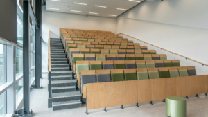 Large university lecture hall with clean seating and aisles before students return.