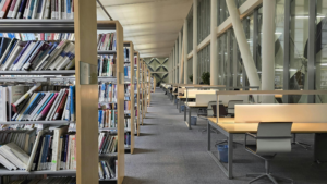 Modern school library with bookshelves, study tables, and clean walkways.