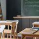 Organized classroom with wooden desks and chalkboard after professional cleaning.