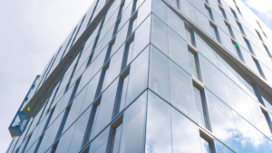 Modern commercial office building with a clean glass exterior.
