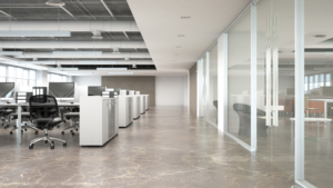 Modern office hallway with clean flooring, glass offices, and bright lighting.