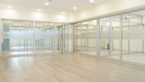 Modern conference room prepared after renovation with clean glass walls and flooring.