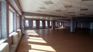 Spacious commercial interior after renovation prepared for occupancy with professional cleaning.