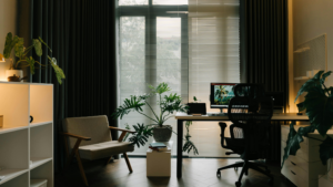 Organized office workspace with desk, computer, chair, and indoor plants