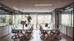 Clean commercial office with workstations and glass partitions