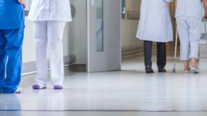 Healthcare professionals walking through a clean hospital hallway
