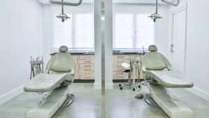 Clean dental treatment room with patient chairs and equipment