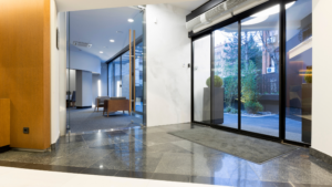 Clean commercial building entrance with polished floors and glass doors
